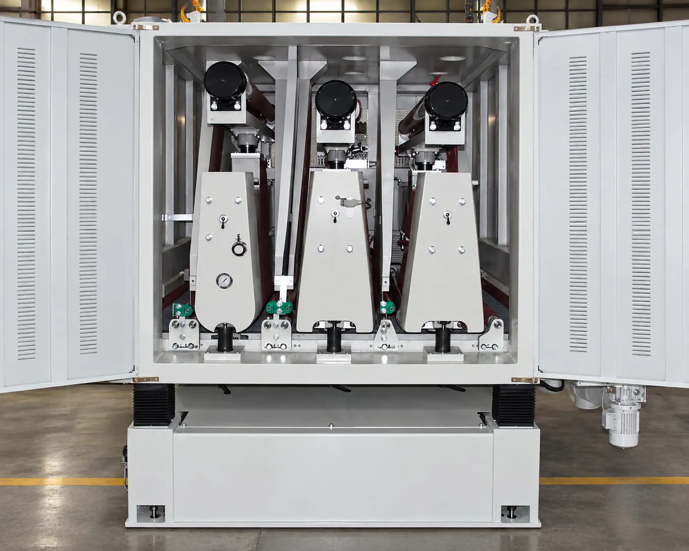 Sanding machine opened up, with the three sanding units in view